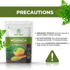 Moringa powder, surrounded by fresh moringa leaves, highlighting its Precautions.