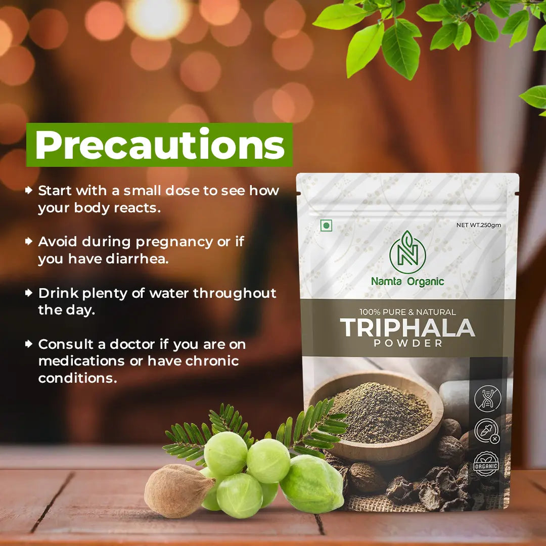 Packaging of "Namta Organic Triphala Powder" is displayed with precautions listed, including dosage advice and health warnings. Earthy background with green leaves.